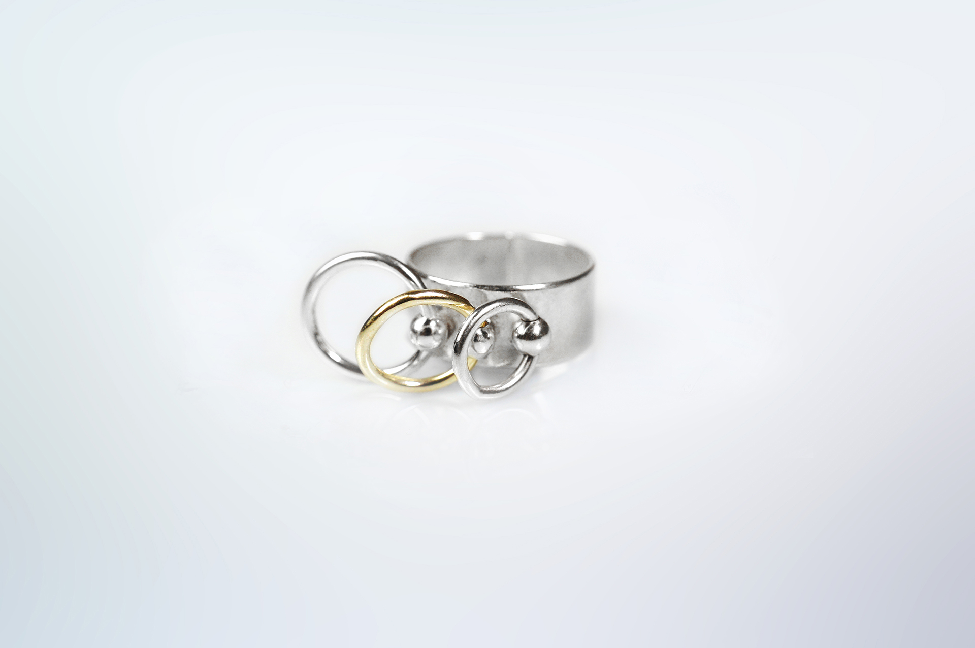 Piasu wide band silver ring with three hoops, one in 18K gold.