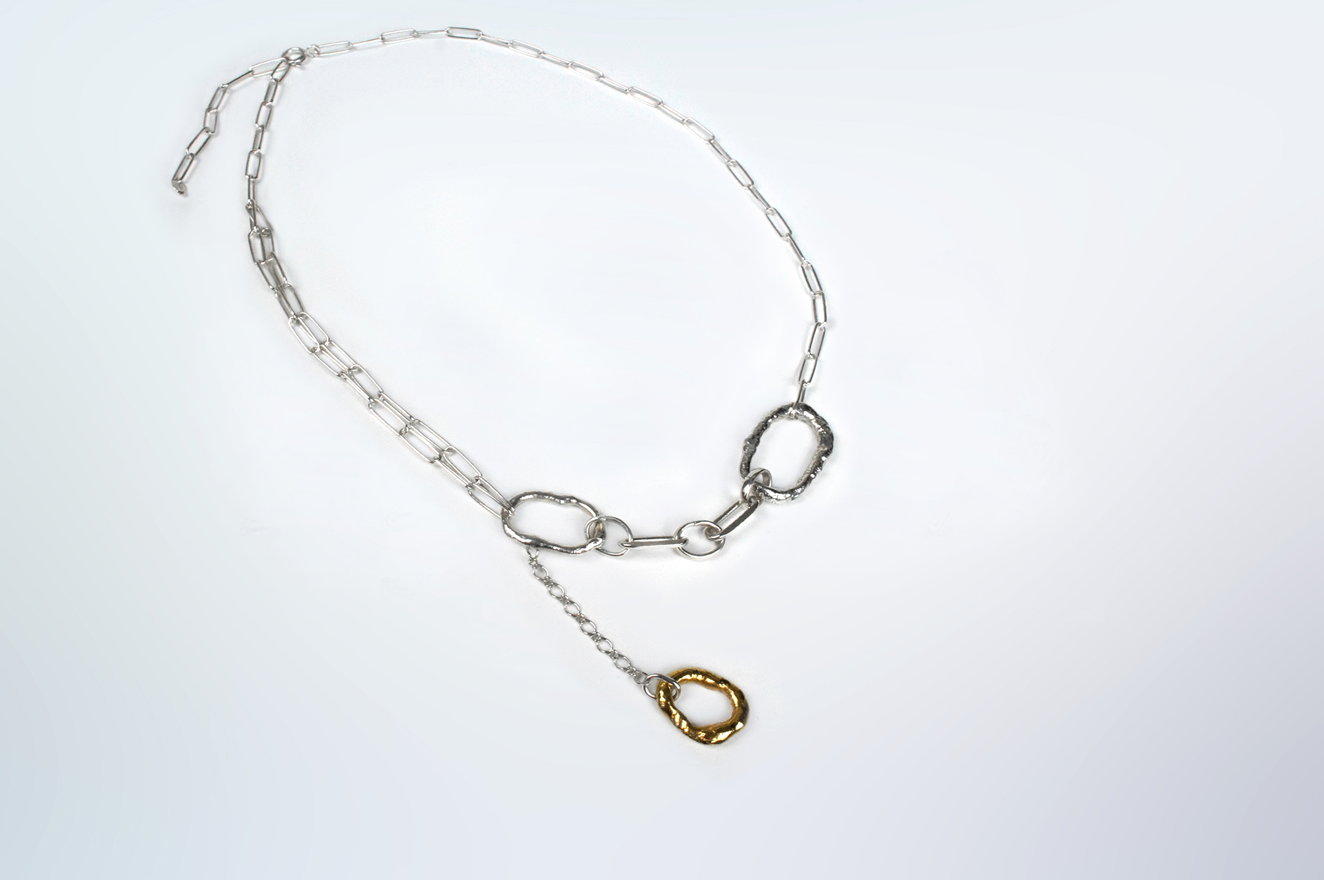 Fuyou sterling silver necklace with rectangle trace chain and fluid elements, gold plated dangling detail.