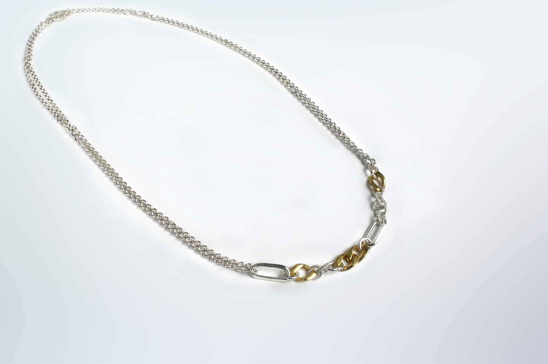 Ikkan necklace in sterling silver with some gold plated links.