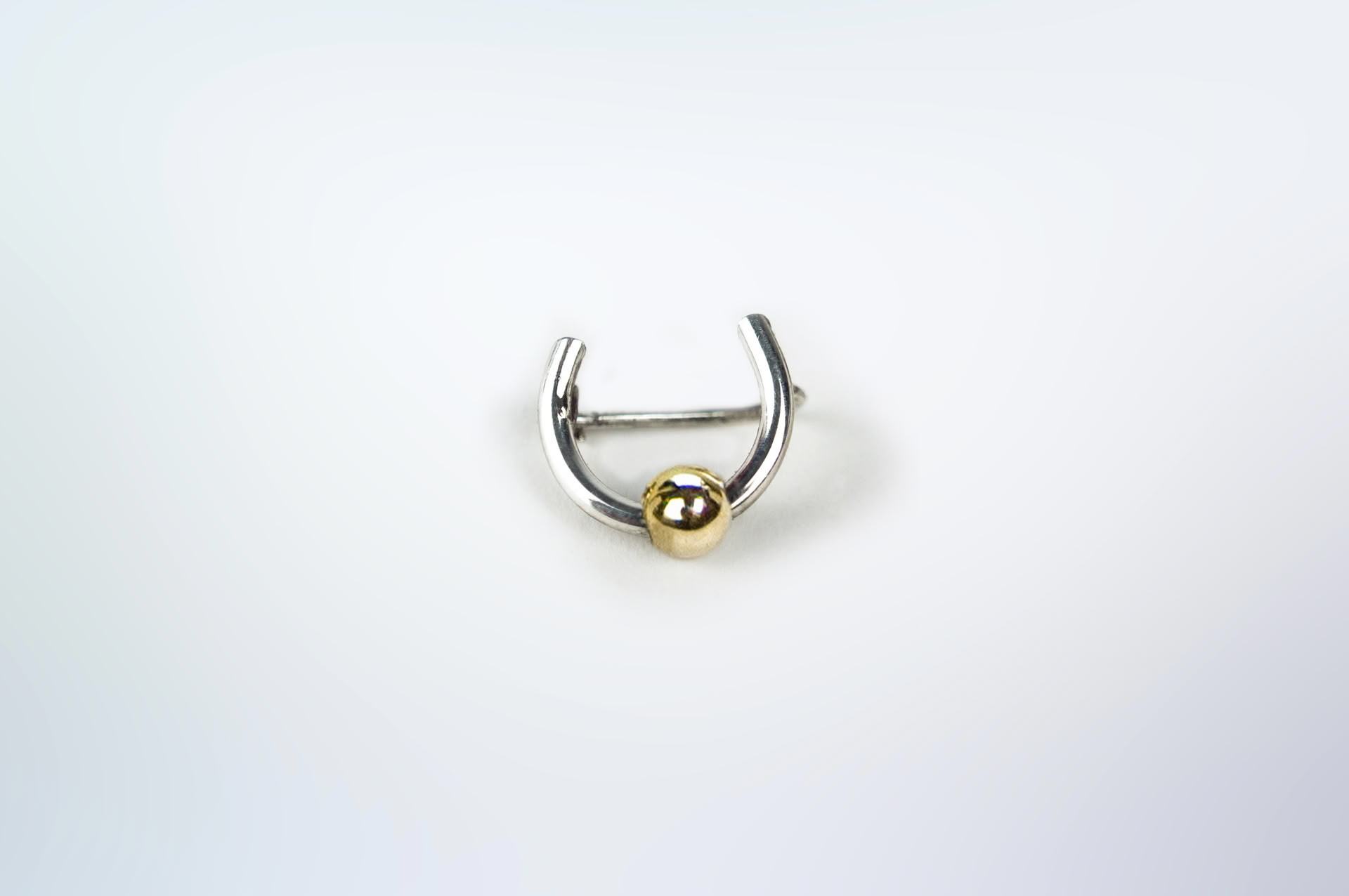 Piasu sterling silver brooch looking like a nipple piercing.