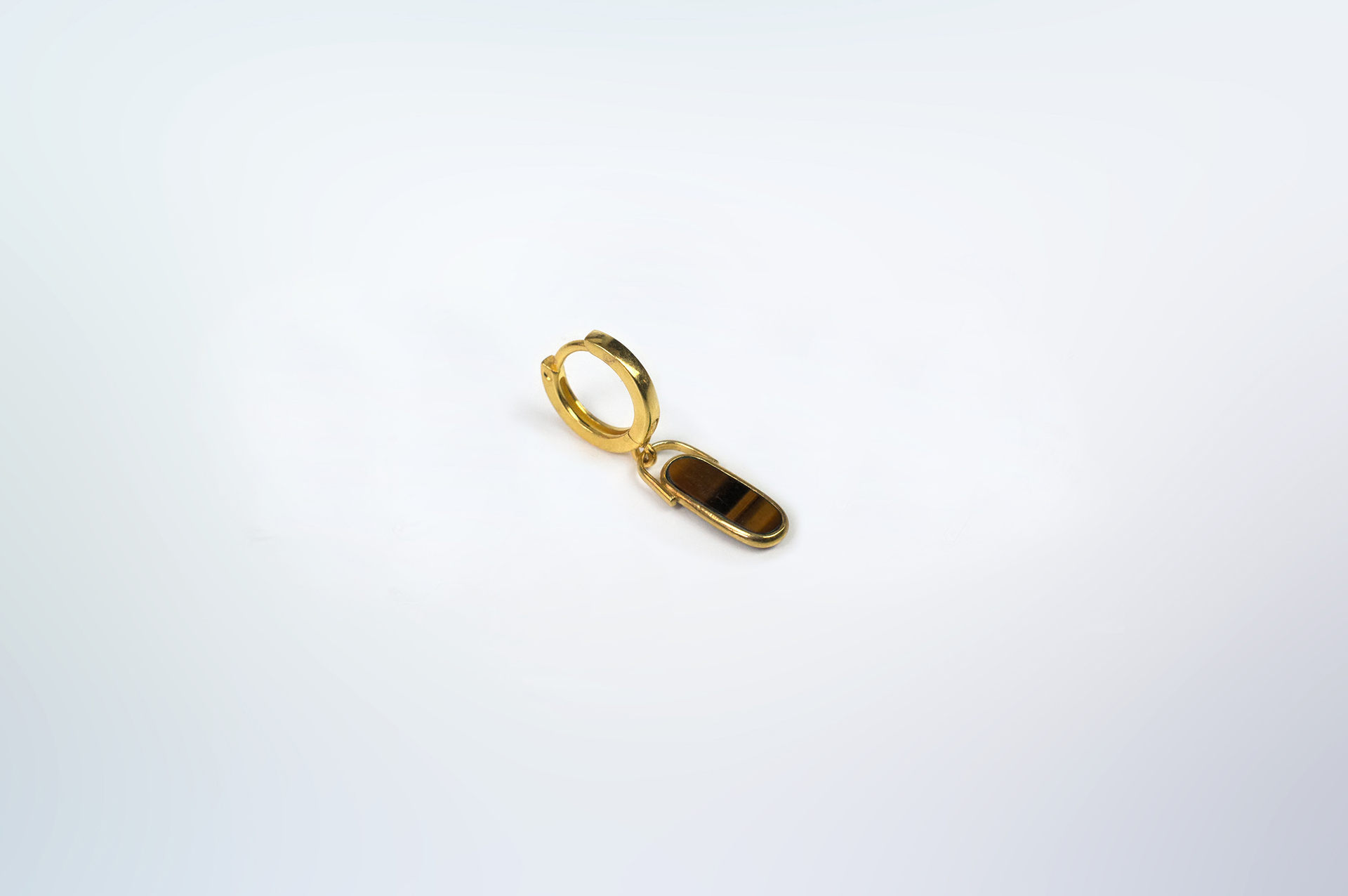 Rokku solo hoop earring in gold plated silver with tiger's eye stone.