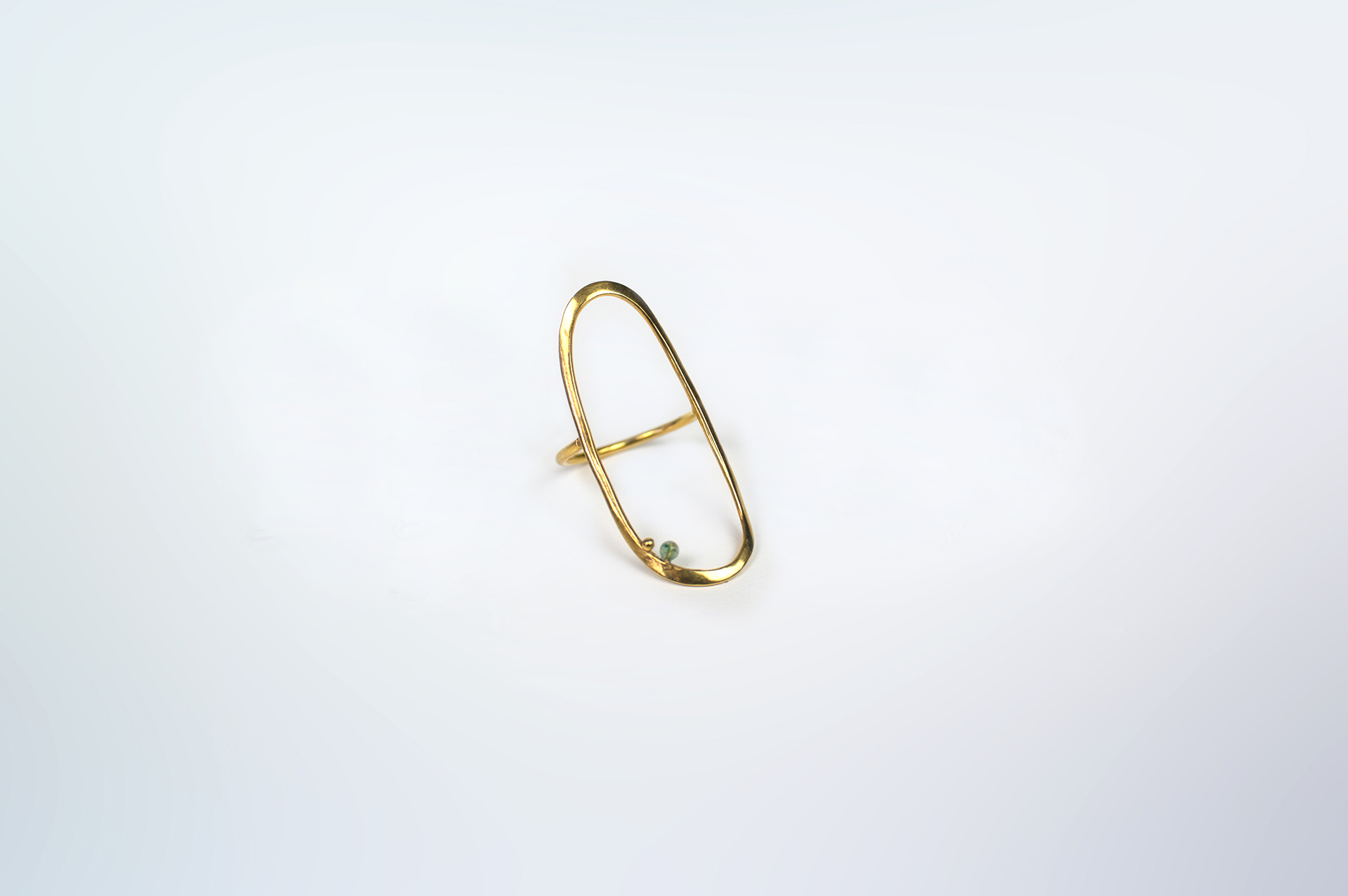 BoroBoro long gold plated oval ring with a small aventurine bead.